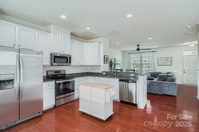 a kitchen with stainless steel appliances and white cabinets
