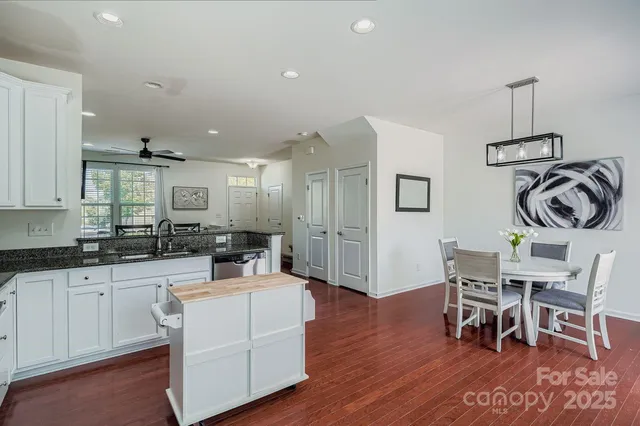 a kitchen with a sink cabinets and wooden floor