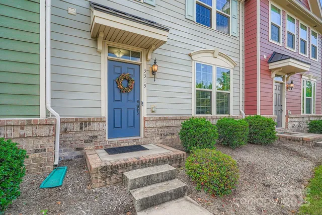 a view of brick house with potted plants