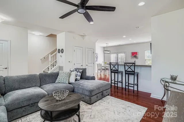a living room with furniture and a wooden floor
