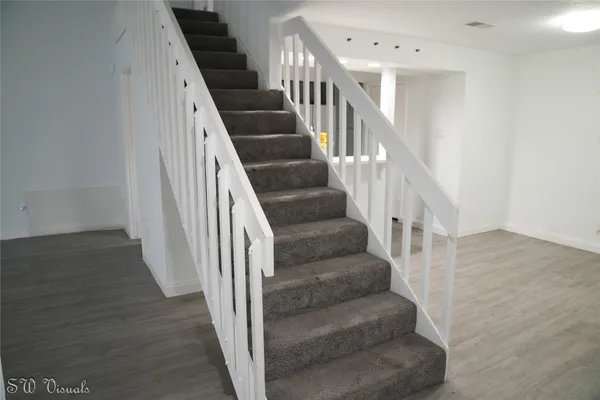 a view of entryway and hall with wooden floor