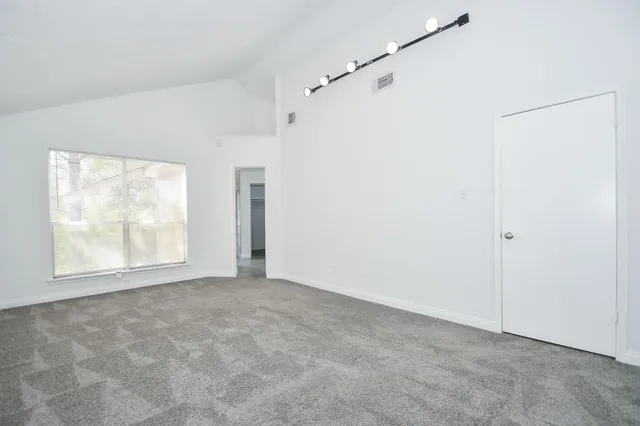 a view of an empty room with a window