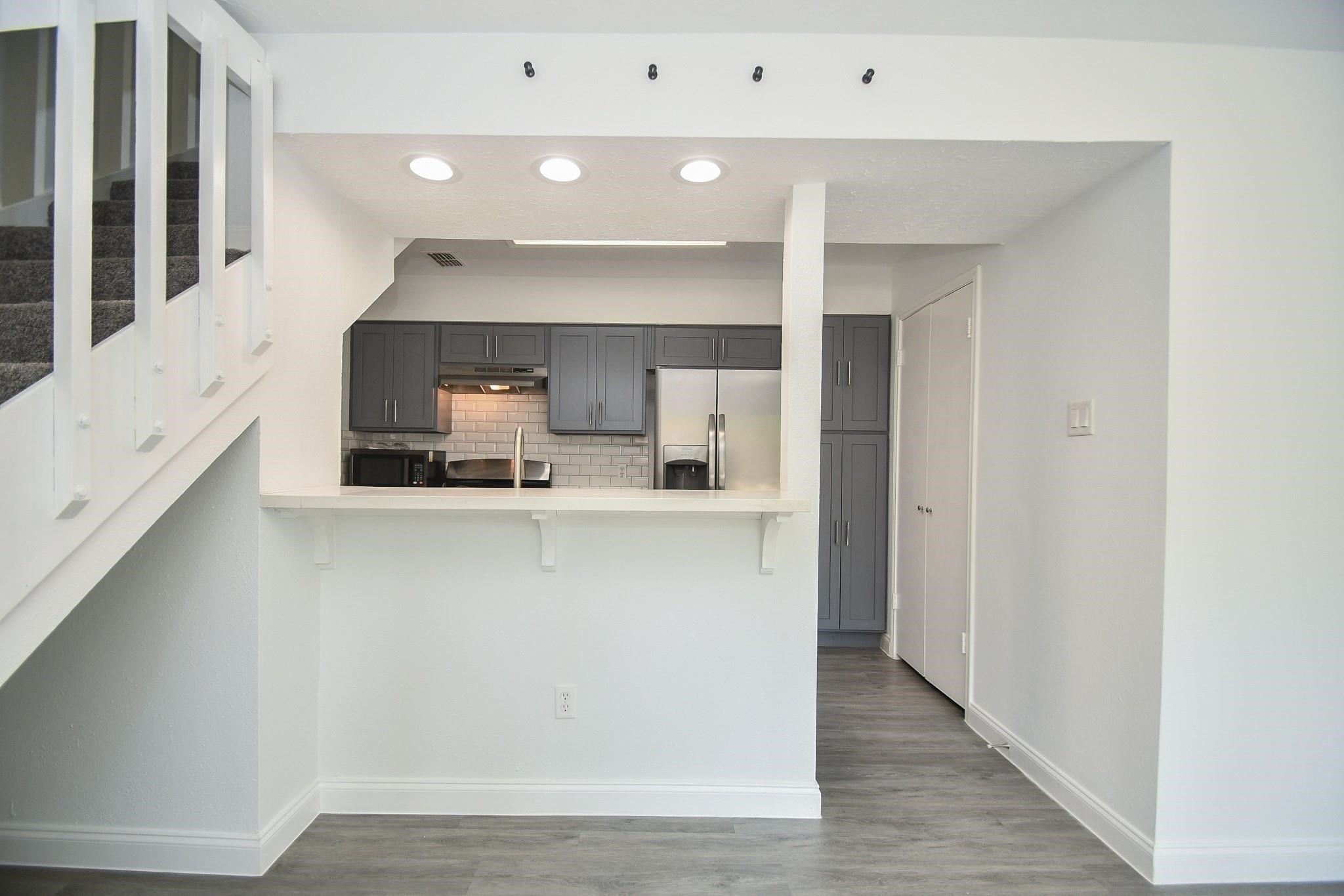 8803 Vinkins Road Houston, TX 77071 - Photo 5 of 9 a kitchen with stainless steel appliances a refrigerator and a stove