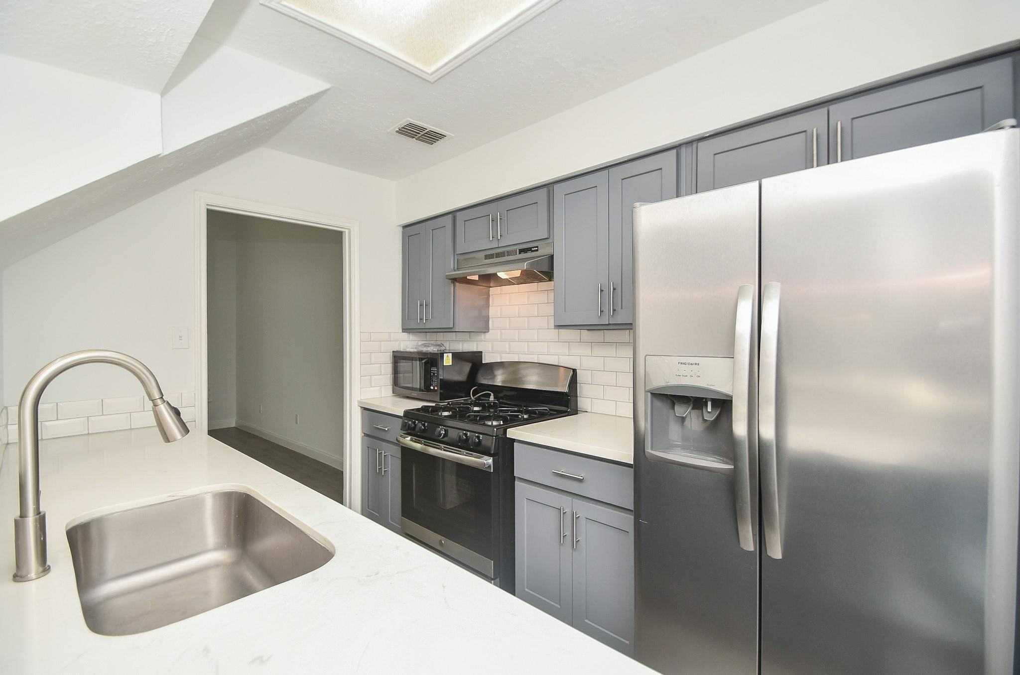8803 Vinkins Road Houston, TX 77071 - Photo 8 of 9 a kitchen with a refrigerator sink and stove