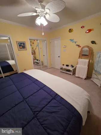 a bedroom with two beds and a chandelier