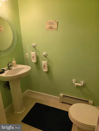 a bedroom with a bed and painting on the wall
