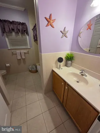 a bathroom with a double vanity sink and a toilet