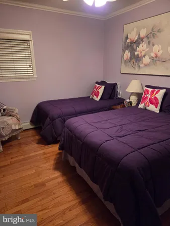 a bedroom with a bed and a chair in it