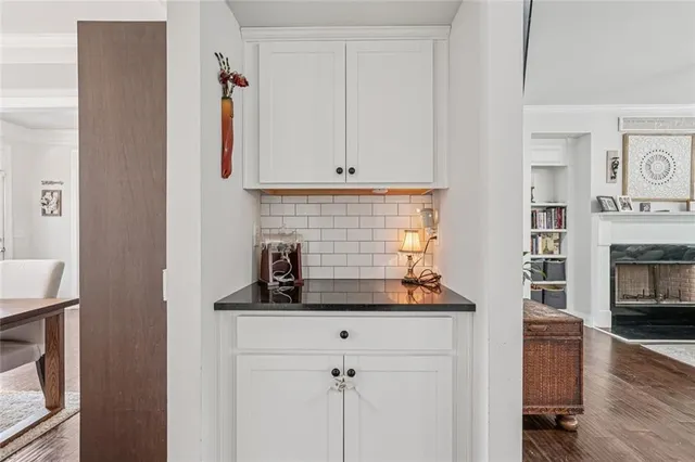a kitchen with granite countertop white cabinets and white appliances