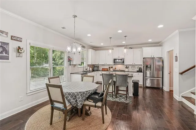 a view of a dining room and livingroom with furniture wooden floor