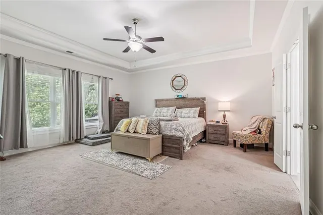 a bedroom with a bed couch and window