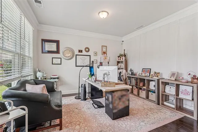 a living room with lots of furniture and baby bed