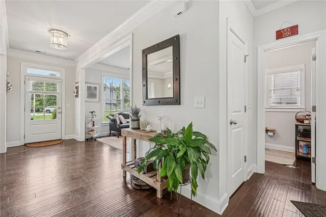 a hallway with wooden floor and furniture
