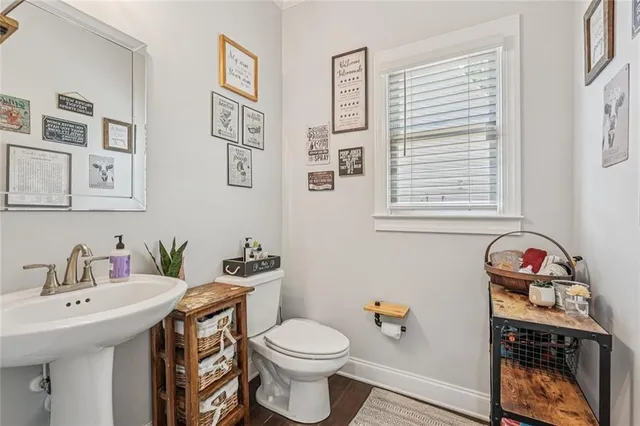 a bathroom with a sink toilet and a window