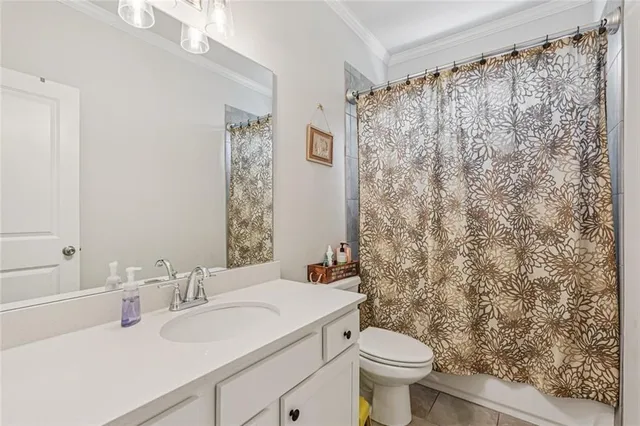 a bedroom with a bed a couch and a large window