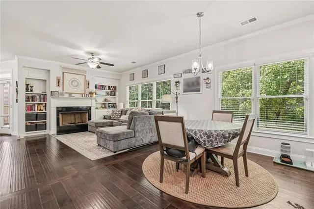 a view of a dining room with furniture wooden floor and chandelier
