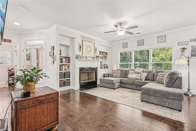 a living room with furniture fireplace and a large window