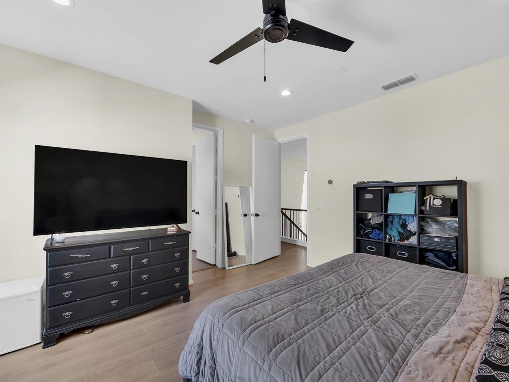 4703 Munger Avenue, Unit 101 Dallas, TX 75204 - Photo 14 of 26 a bedroom with a bed and a flat screen tv