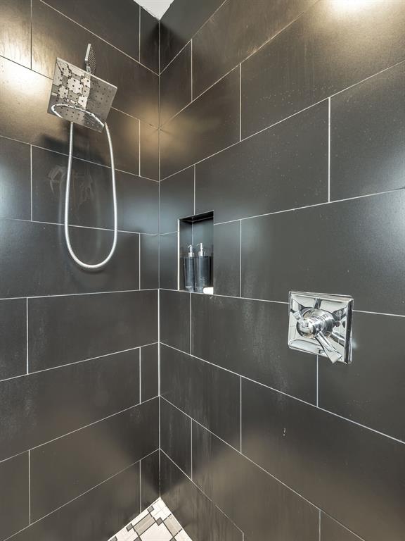 4703 Munger Avenue, Unit 101 Dallas, TX 75204 - Photo 16 of 26 a bathroom with a light fixture and a shower