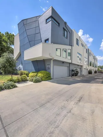 a front view of a building with a yard and garage