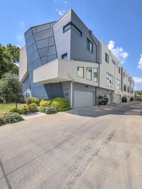 4703 Munger Avenue, Unit 101 Dallas, TX 75204 - Photo 25 of 26 a front view of a building with a yard and garage