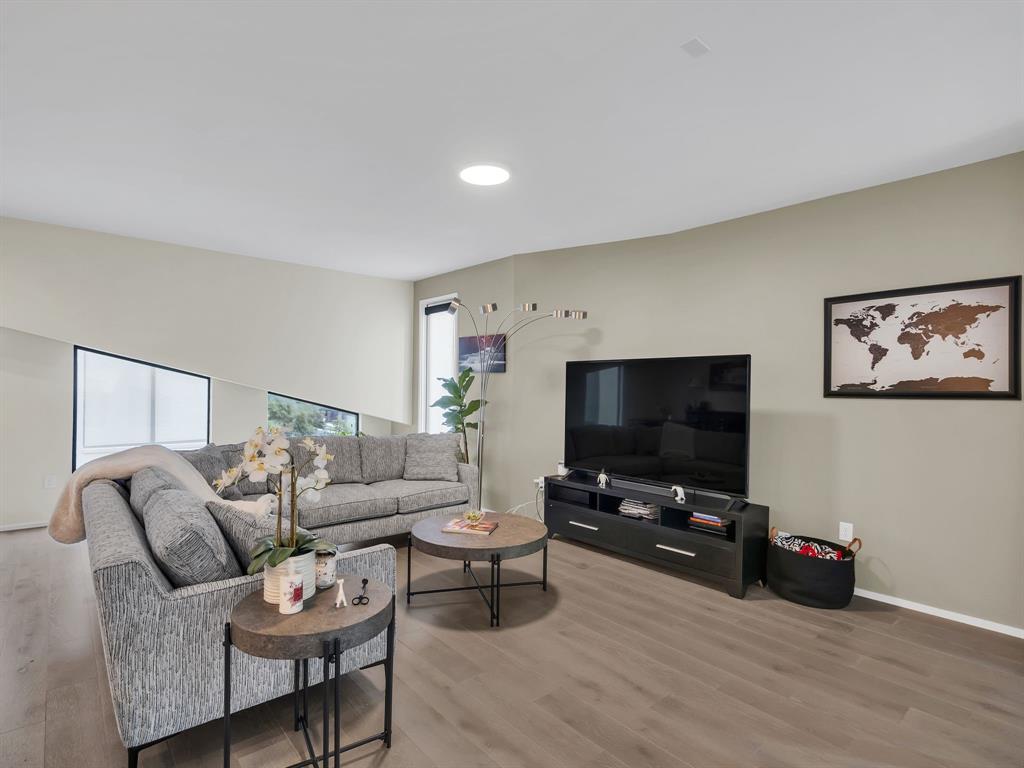 4703 Munger Avenue, Unit 101 Dallas, TX 75204 - Photo 5 of 26 a living room with furniture and a flat screen tv