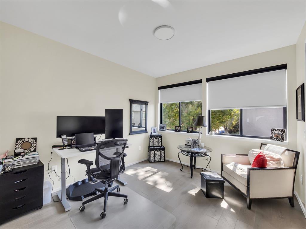 4703 Munger Avenue, Unit 101 Dallas, TX 75204 - Photo 7 of 26 a living room with furniture and a flat screen tv