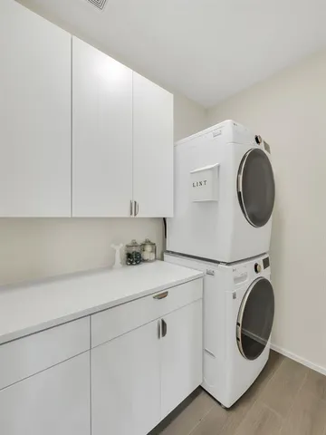 a utility room with sink dryer and washer