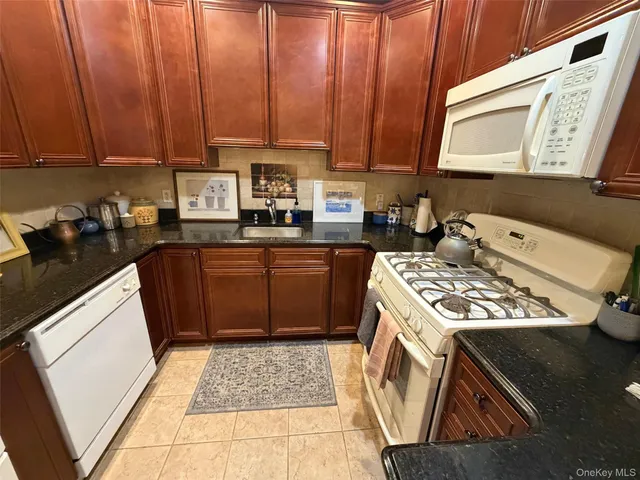 a kitchen with a stove a sink and a microwave