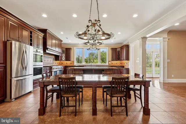 a kitchen with stainless steel appliances granite countertop a stove refrigerator and cabinets