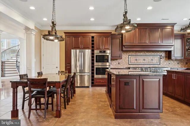 a large kitchen with a table and chairs