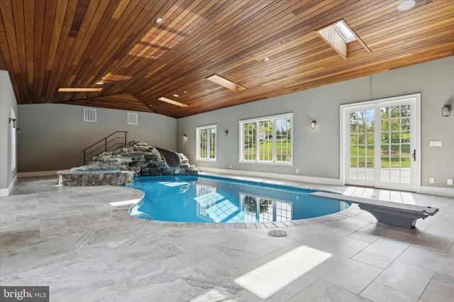 a bathroom with a granite countertop sink a toilet and a large mirror