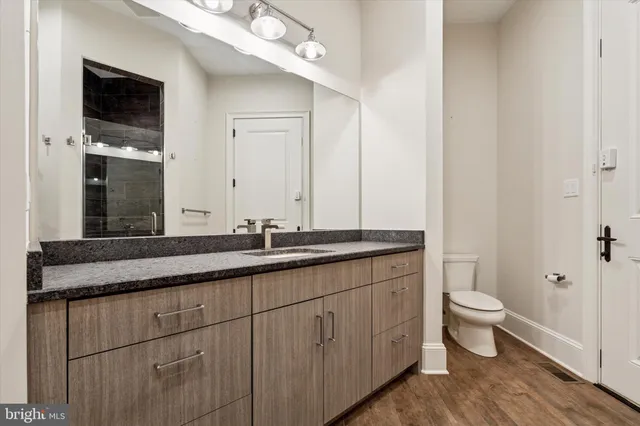 a bathroom with a sink vanity and mirror