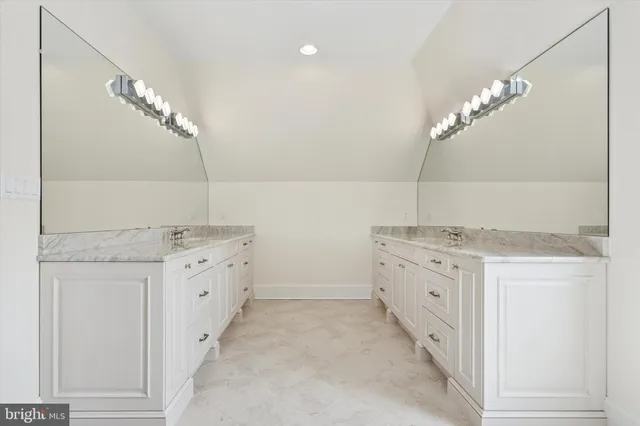 a kitchen with granite countertop a sink and cabinets