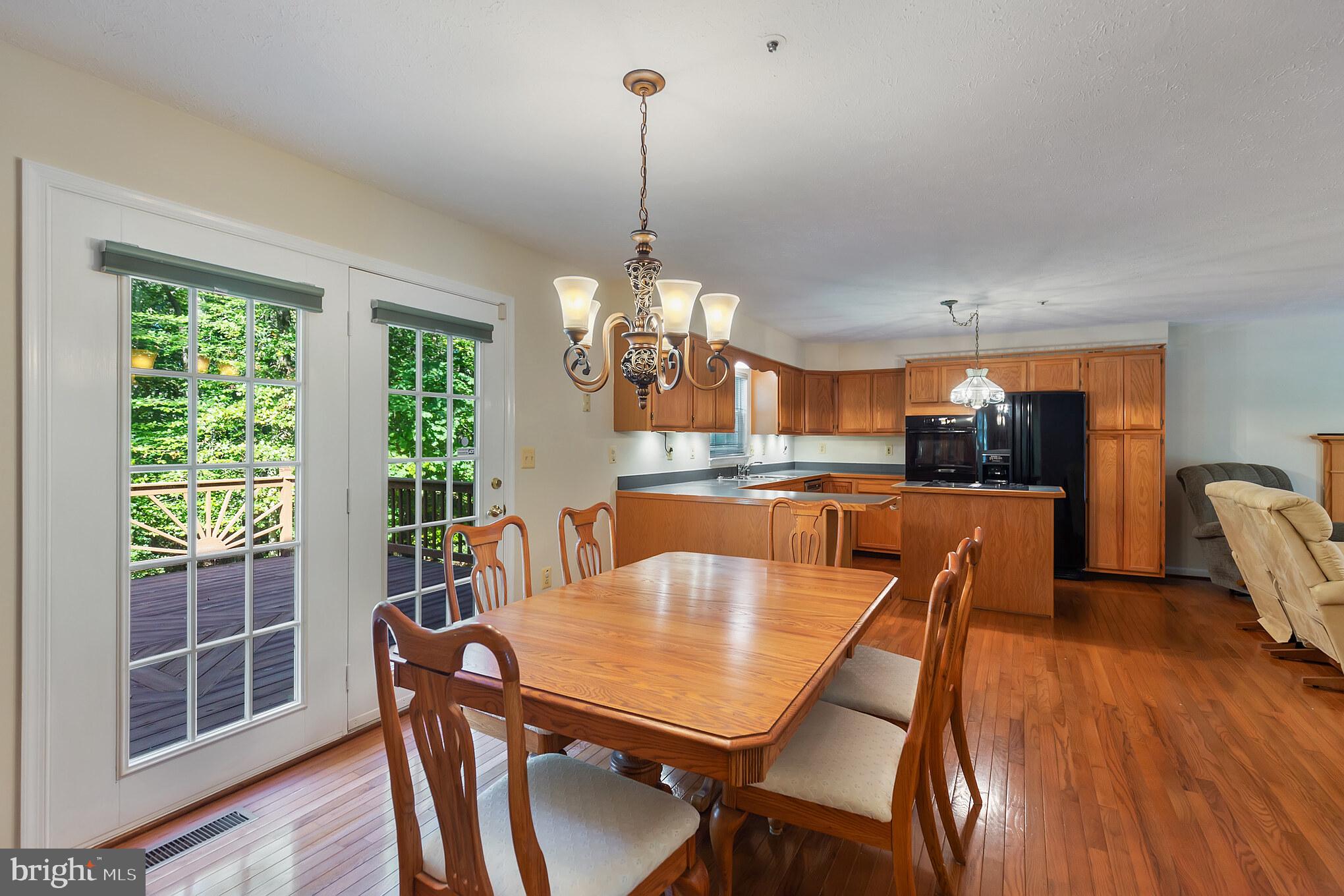640 Small Reward Road Huntingtown, MD 20639 - Photo 4 of 28 a view of a dining room with furniture window and wooden floor