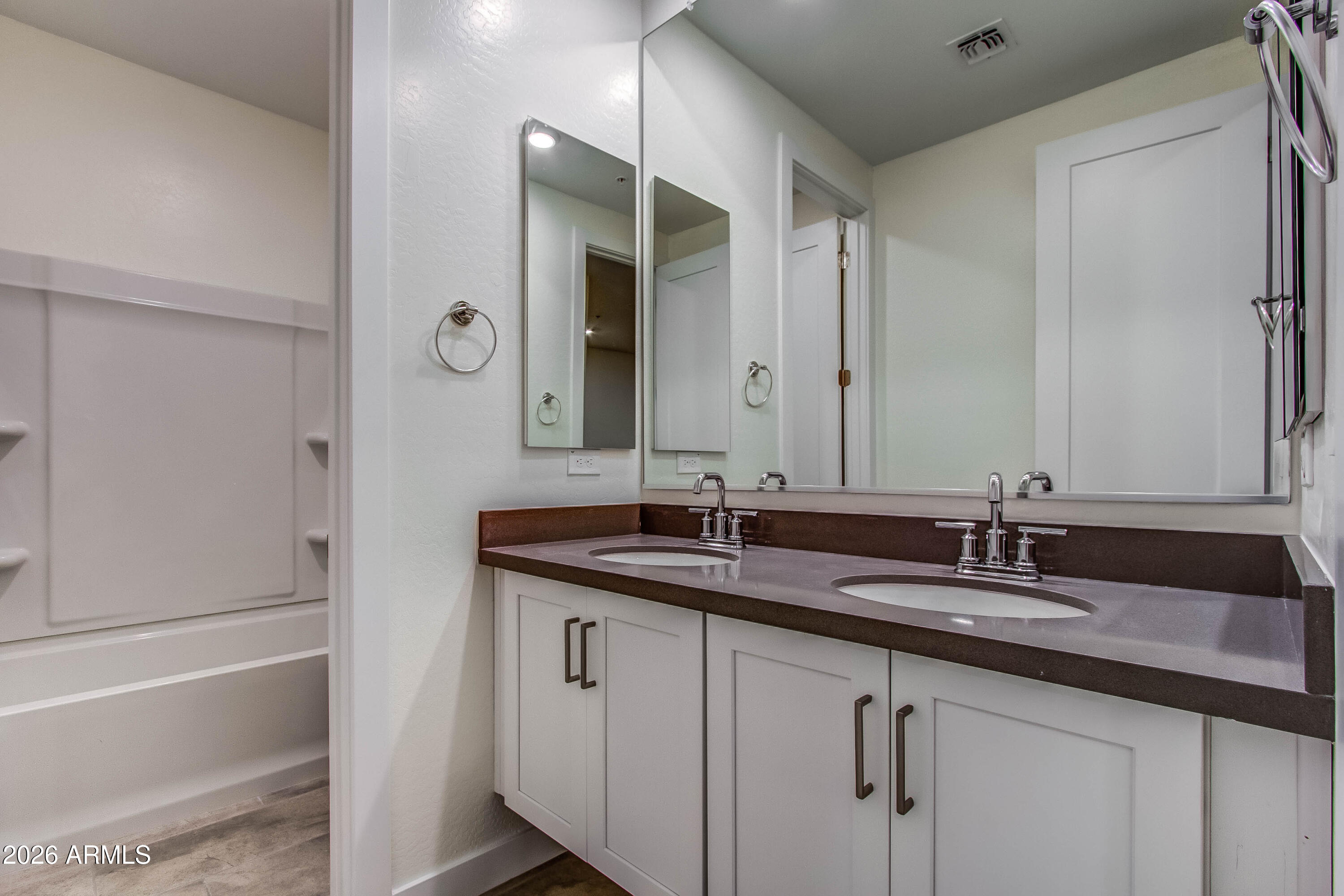 3855 South McQueen Road, Unit 50 Chandler, AZ 85286 - Photo 12 of 14 a bathroom with a granite countertop sink and a mirror