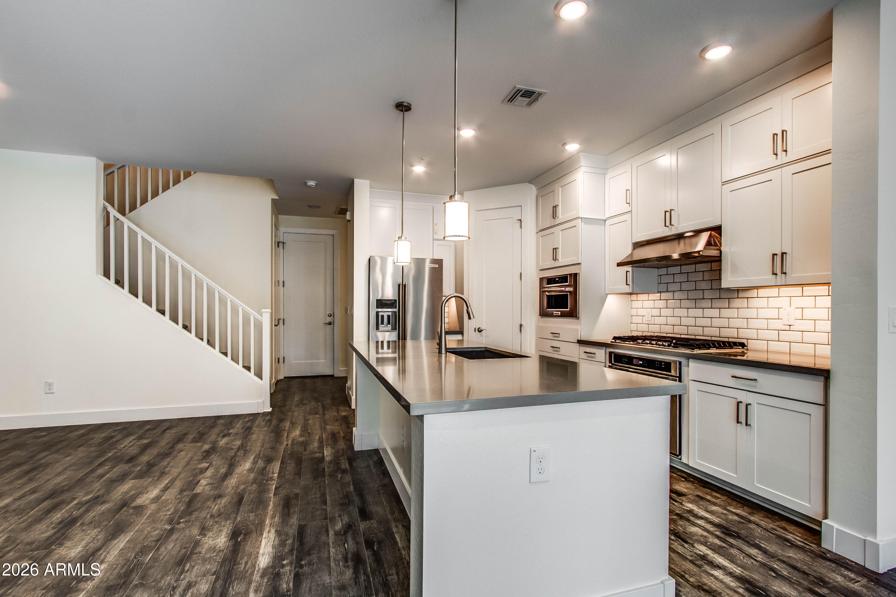 3855 South McQueen Road, Unit 50 Chandler, AZ 85286 - Photo 3 of 14 a kitchen with stainless steel appliances granite countertop a sink stove and refrigerator
