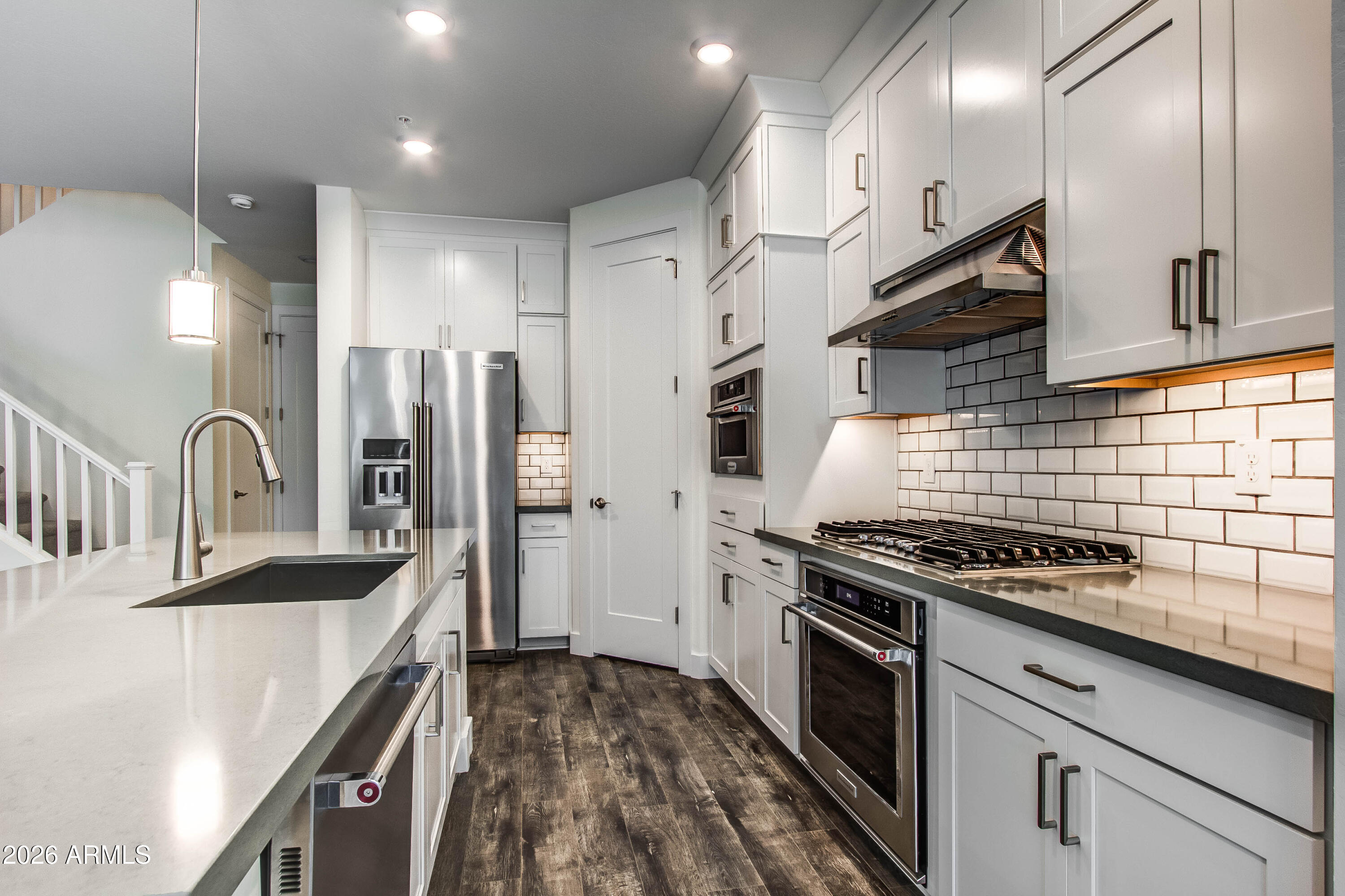 3855 South McQueen Road, Unit 50 Chandler, AZ 85286 - Photo 4 of 14 a kitchen with stainless steel appliances kitchen island granite countertop a stove and a sink