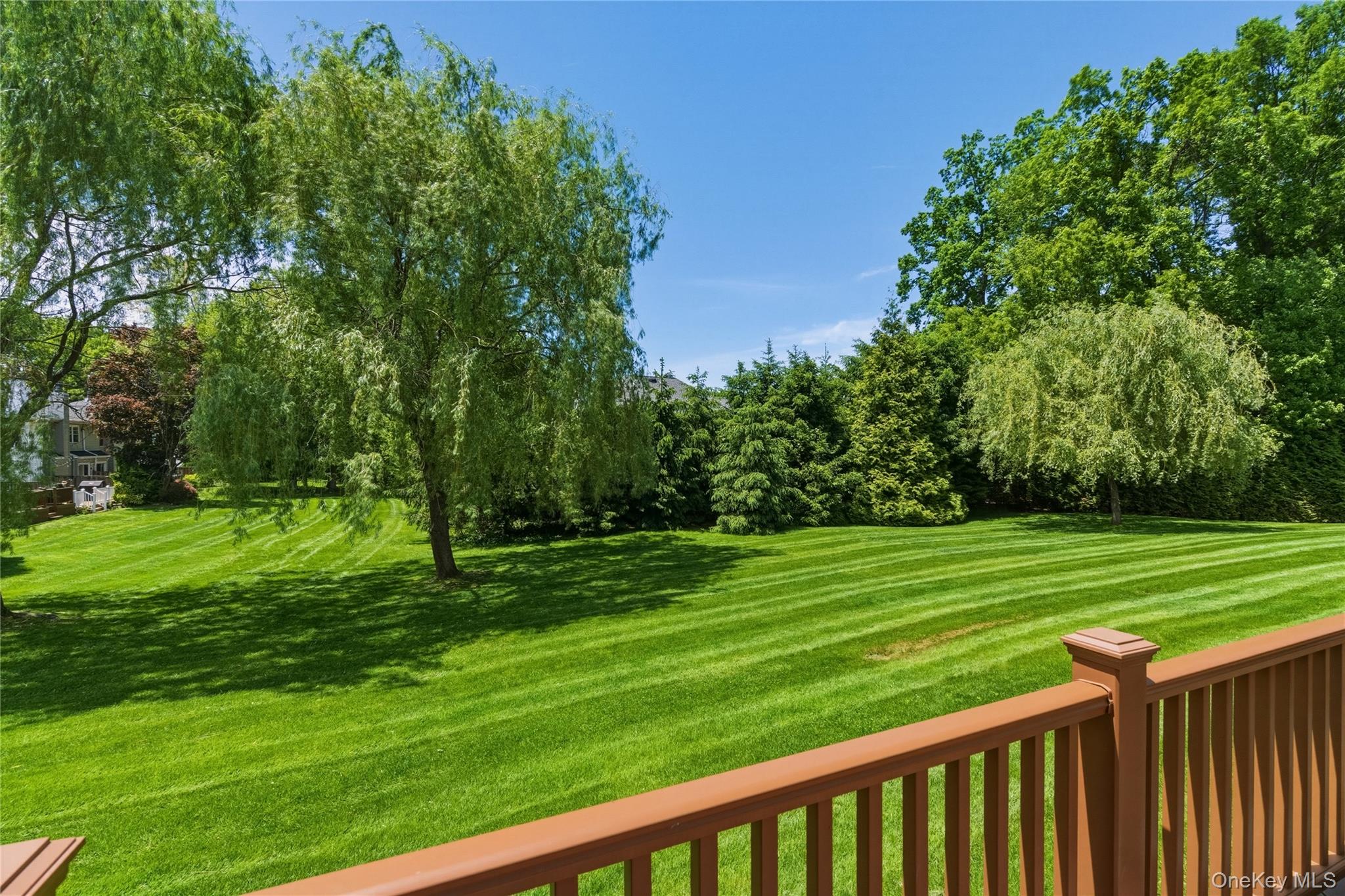 44 Hidden Ridge Drive Syosset, NY 11791 - Photo 19 of 28 a view of a wooden deck and a yard with seating area