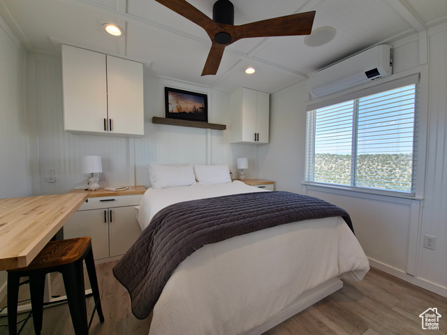 900 Altamont Road Evanston, WY 82930 - Photo 9 of 27 Bedroom featuring light wood-style flooring, a wall mounted air conditioner, recessed lighting, and ceiling fan