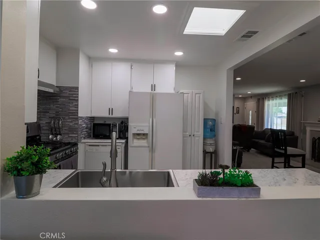 a kitchen with a refrigerator and a sink