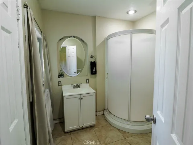 a bathroom with a double vanity sink a toilet and a mirror