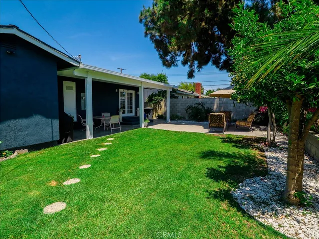 a view of a house with a yard porch and sitting area