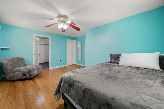 a bedroom with a large bed and a chandelier