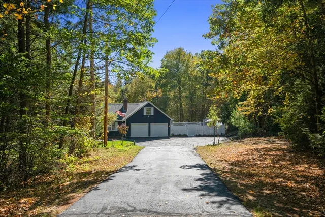 a view of a house with a tree in the background
