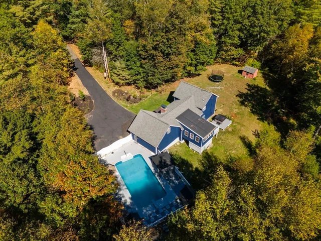 an aerial view of a house with a yard