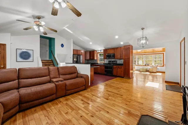 a living room with furniture kitchen and a chandelier