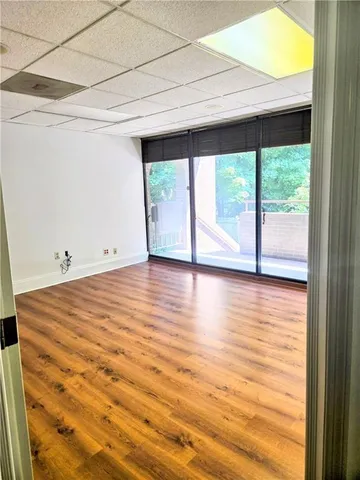 a view of room with window and wooden floor