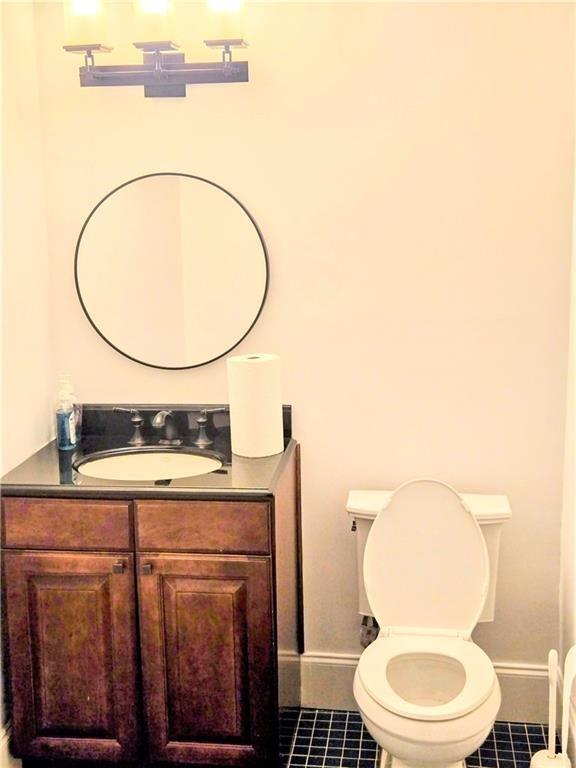 1549 Clairmont Road, Unit 208 Decatur, GA 30033 - Photo 7 of 7 a bathroom with a toilet a sink and mirror
