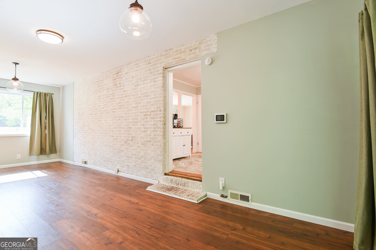 545 Forest Hill Road Macon, GA 31210 - Photo 35 of 63 an empty room with wooden floor and windows